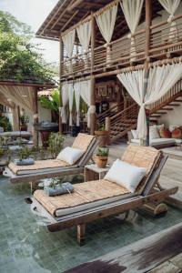 a group of chaise lounges on a patio at Pousada Encantada in Trancoso