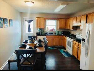 a kitchen with wooden cabinets and a table with chairs at The Great Escape King suite, Kid friendly in Sevierville