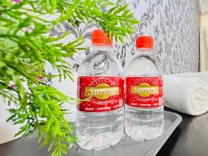 two bottles of water sitting on top of a table at Sarina Hotel, Jeli in Jeli