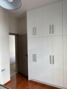 a room with white cabinets and a ceiling at A Modern & Homely 1BR Apartment in Chios