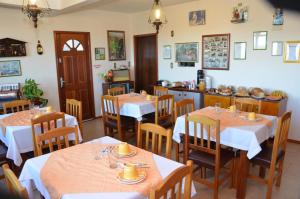 a restaurant with tables and chairs and a counter at Pousada Colina Da Neve in São Joaquim +20 photos