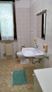 a bathroom with a white sink and a toilet at Aqua Lake Como in Acquaseria +25 photos