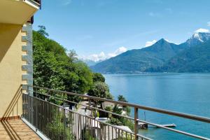 a balcony with a view of a lake and mountains at Aqua Lake Como in Acquaseria