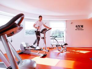 a man standing on a treadmill in a gym at Ibis Luxembourg Airport in Luxembourg