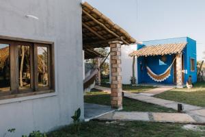 a house with a garland on the side of it at Vila Aracatí Pousada in Santo Amaro