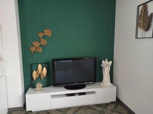 a flat screen tv sitting on a white entertainment center at Noclegi u Uli in Konin
