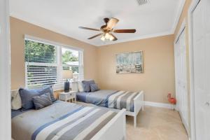 Un dormitorio con dos camas y un ventilador de techo. en Dreamyard Prime Location Pool, en Boynton Beach 49 fotos más