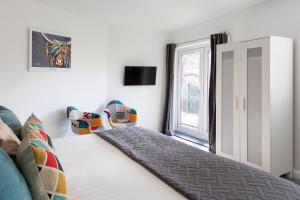 a bedroom with a bed and a window at The Little Mill Inn in New Mills