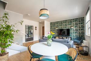 a living room with a table and a couch at L'Attico del Corso in Trieste