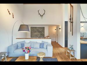 a living room with a blue couch and a table at Villa Wanderlust in Reit im Winkl
