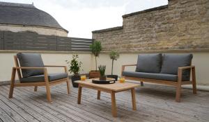 two chairs and a coffee table on a patio at Cosy Gare in Caen