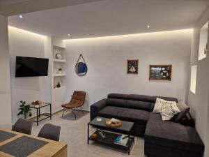 a living room with a couch and a table at Cozy Apartment in Asprovalta