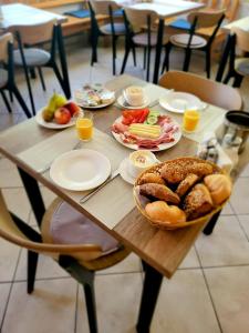 a wooden table with plates of food on it at Hotel Alpin Murau in Murau