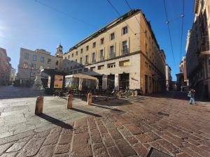 a person walking down a street in front of a building at Le Cœur Urban Suite Parma in Parma
