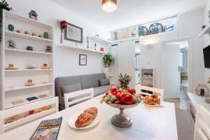 een keuken en een woonkamer met een tafel met een fruitschaal bij Lucca Old Town Apartment in Lucca
