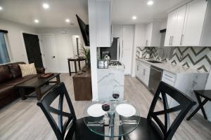a kitchen and living room with a table and chairs at Upper West Newport in Newport Beach