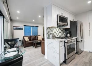 a kitchen with a stove top oven next to a living room at Upper West Newport in Newport Beach