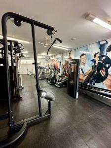 a gym with several people exercising in machines at Caldas Novas - Prive das Thermas II - Apto 3 quartos - Parque Aquático in Caldas Novas