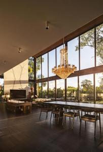 a dining room with a table and chairs and a chandelier at VILLA GIMA 1 - 5 bedroom UMALAS in Kerobokan