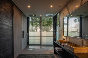 a bathroom with two sinks and a large mirror at VILLA GIMA 1 - 5 bedroom UMALAS in Kerobokan +14 photos