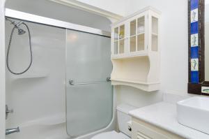 a bathroom with a shower and a toilet and a sink at Shearin by Bryant Real Estate in Wrightsville Beach