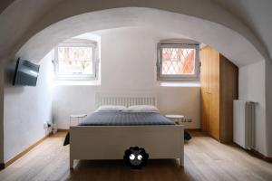 Postel nebo postele na pokoji v ubytování Flat Il Torrazzo XIII Secolo