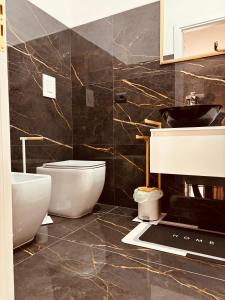 a bathroom with a toilet and a sink at B&B A un passo dal mare in Crotone +23 photos