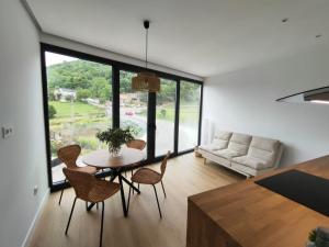 a living room with a table and chairs and a couch at Casa Tome A Teixeira - Ribeira Sacra in Teixeira