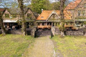 a house with a table and chairs in front of it at Villa Zeeweg in Bergen aan Zee