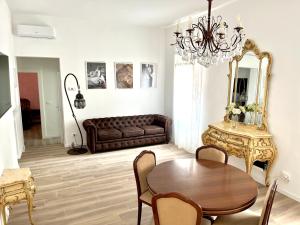 a living room with a couch and a table at Airoldi Palace Apartment in Chioggia +10 photos