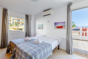 a bedroom with a bed and a large window at A&n Moriles, Torre del Mar in Torre del Mar +72 photos