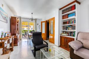 a living room with a couch and a chair and a table at A&n Moriles, Torre del Mar in Torre del Mar