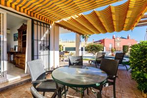 a patio with a table and chairs on a porch at A&n Moriles, Torre del Mar in Torre del Mar