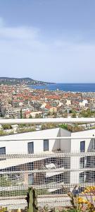 a large white building with a view of a city at Chambre vue Nice & mer in Nice +10 photos