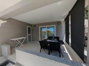 an open balcony with a desk in a house at Olive Tree Apartment Zečevo in Rogoznica