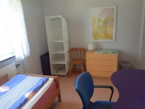a bedroom with a bed and a desk and a chair at Honeymoon Guesthouse in Helsingborg
