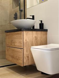 a bathroom with a white sink and a toilet at CentraLuxury in Piatra Neamţ +26 photos