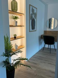 a living room with a plant and a desk at CentraLuxury in Piatra Neamţ