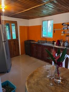 a kitchen with a table with wine glasses on it at Hacienda Valencia in Santa Marta