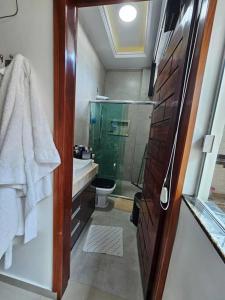 a bathroom with a shower and a sink and a toilet at Apartamento Premium in Parintins