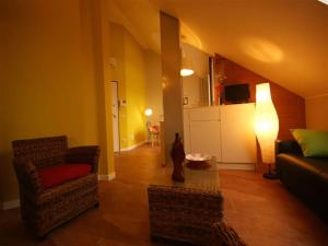 a living room with a couch and a chair at Sinfonia Tintoretto Central 2-Room-Flat in Verbania