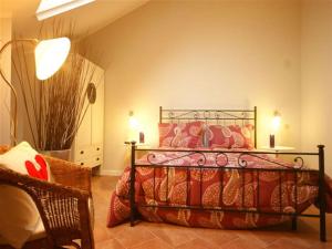 a bedroom with a bed and a chair and lights at Sinfonia Tintoretto Central 2-Room-Flat in Verbania