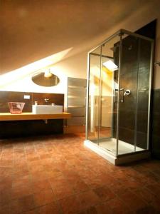a bathroom with a glass shower and a sink at Sinfonia Tintoretto Central 2-Room-Flat in Verbania