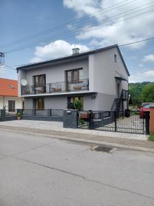 a white house on the side of a street at U Poličky in Banská Bystrica