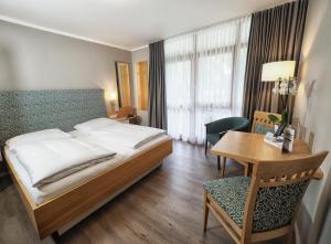 Postel nebo postele na pokoji v ubytování City Appartementhotel + 14 fotografií