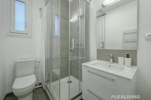 a bathroom with a shower and a toilet and a sink at Flexliving - Room - Henri Sellier - Suresnes 92 in Suresnes +1 photo