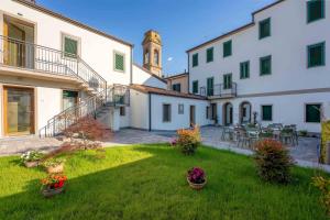 a courtyard of a building with a clock tower at Villa Carducci in Comacchio