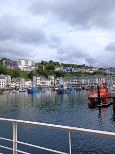 a view of a harbor with boats in the water at La Casina independiente de Bruno,de dos dormitorios cerca de la playa in Cudillero