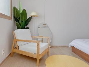 a room with a chair and a lamp and a bed at 4 bed 3 room near Gimpo airport in Seoul