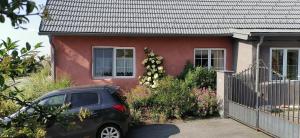 a car parked in front of a house at Rita's FeWo in Grossschönau +5 photos